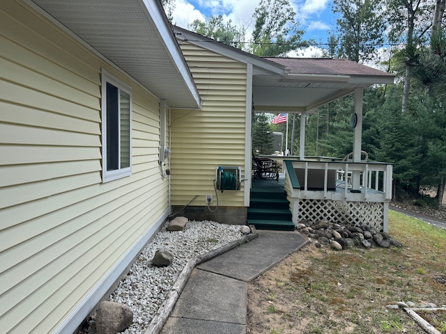 view of exterior entry featuring a deck