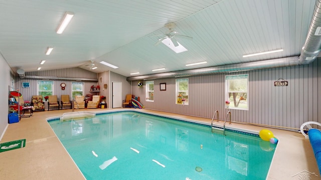 view of swimming pool with a skylight and ceiling fan