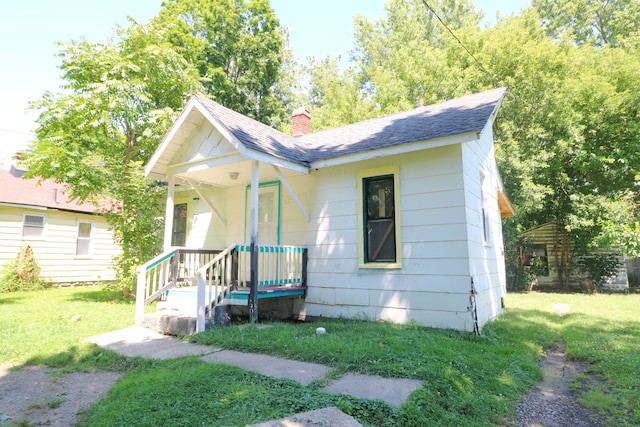 bungalow-style house featuring a front yard