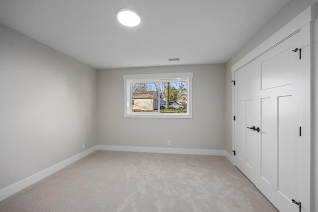 unfurnished bedroom featuring light colored carpet