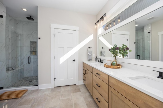 bathroom with vanity and a shower with shower door