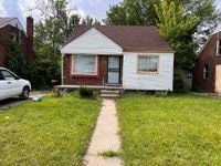 bungalow-style house featuring a front yard