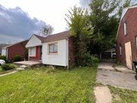 view of side of property with a lawn