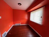 unfurnished room featuring hardwood / wood-style flooring and beam ceiling