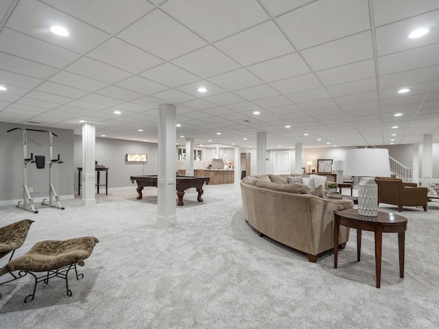 carpeted living room featuring a drop ceiling and pool table