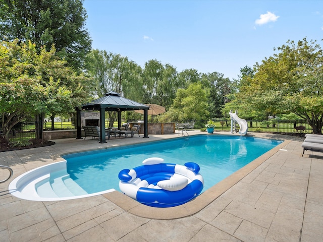 view of pool with a gazebo, a patio, and a water slide