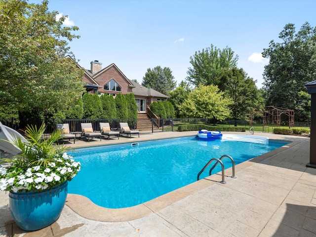 view of swimming pool with a patio