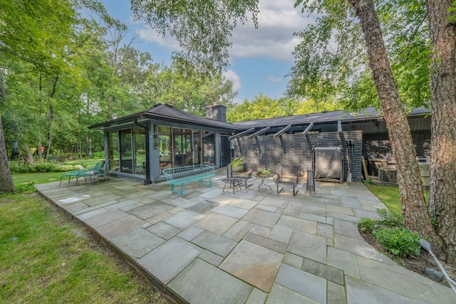 view of patio featuring a sunroom