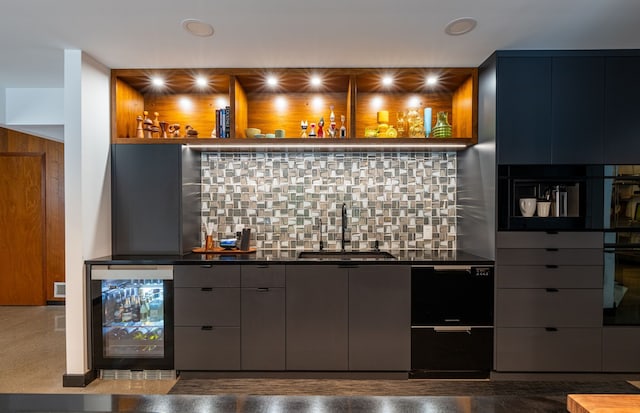 bar with tasteful backsplash, wall oven, beverage cooler, and sink