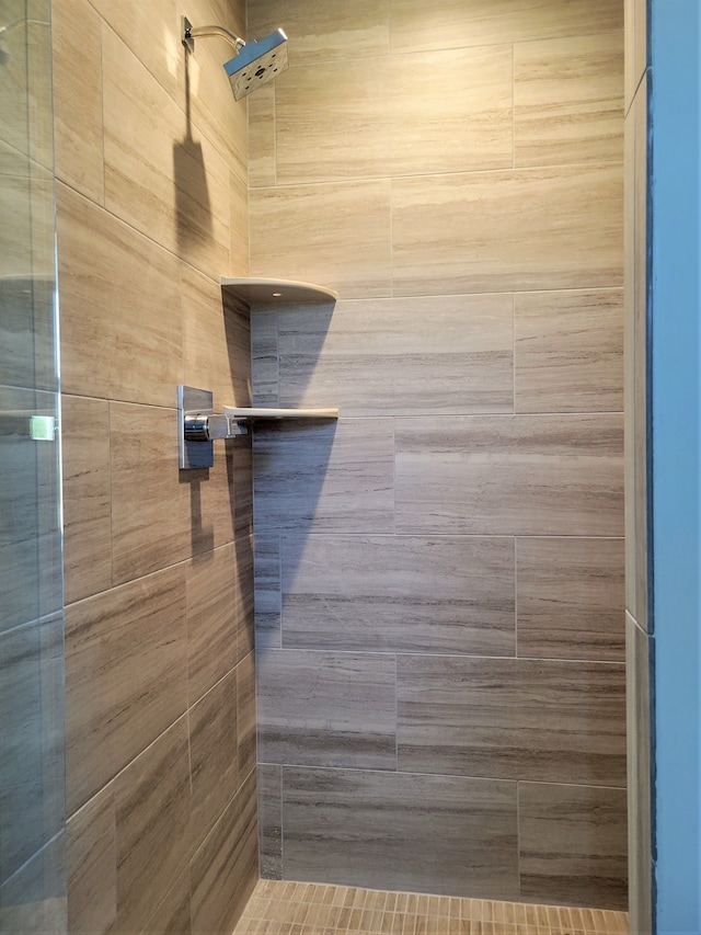 bathroom with tiled shower