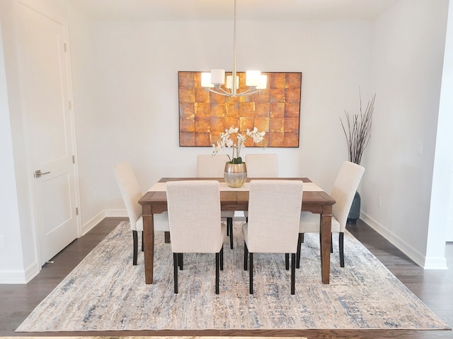 dining area featuring dark hardwood / wood-style flooring and a notable chandelier