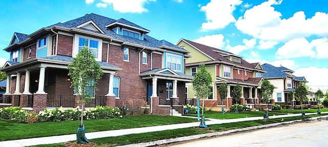 craftsman house featuring a porch and a front lawn