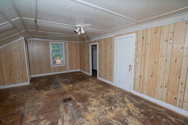 bonus room featuring wooden walls and vaulted ceiling