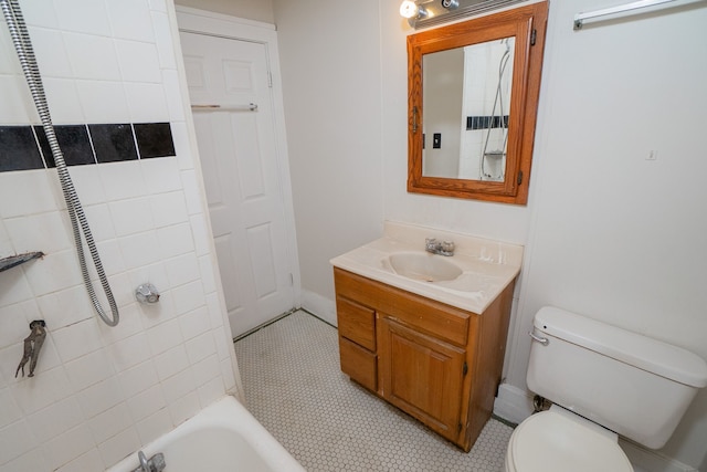 full bathroom featuring tile patterned floors, vanity, toilet, and tiled shower / bath combo