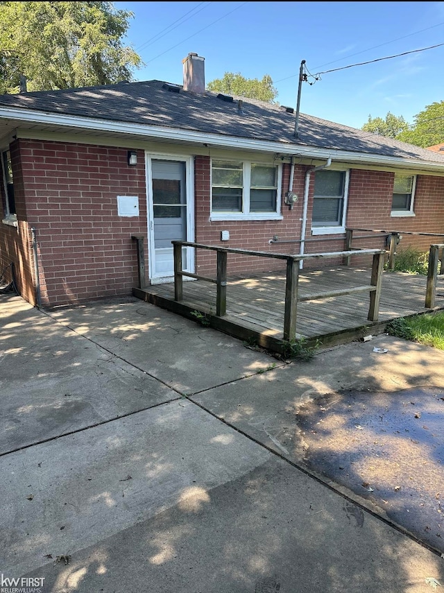 rear view of house with a patio area and a wooden deck