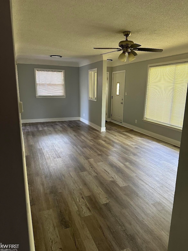 empty room with ceiling fan, hardwood / wood-style floors, and a textured ceiling