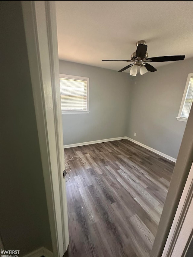 spare room with ceiling fan and dark hardwood / wood-style flooring