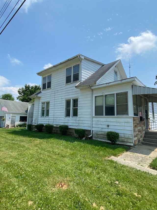 back of house with a lawn