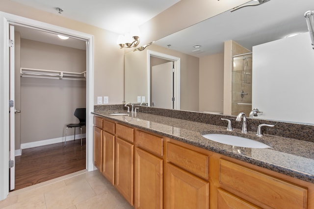 bathroom featuring vanity, an enclosed shower, and tile patterned floors