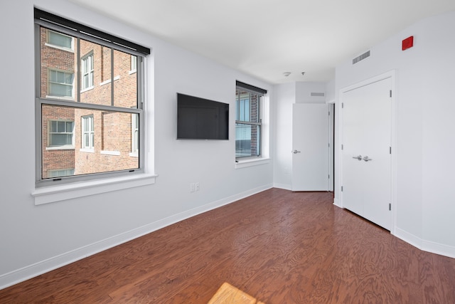 empty room with dark hardwood / wood-style floors