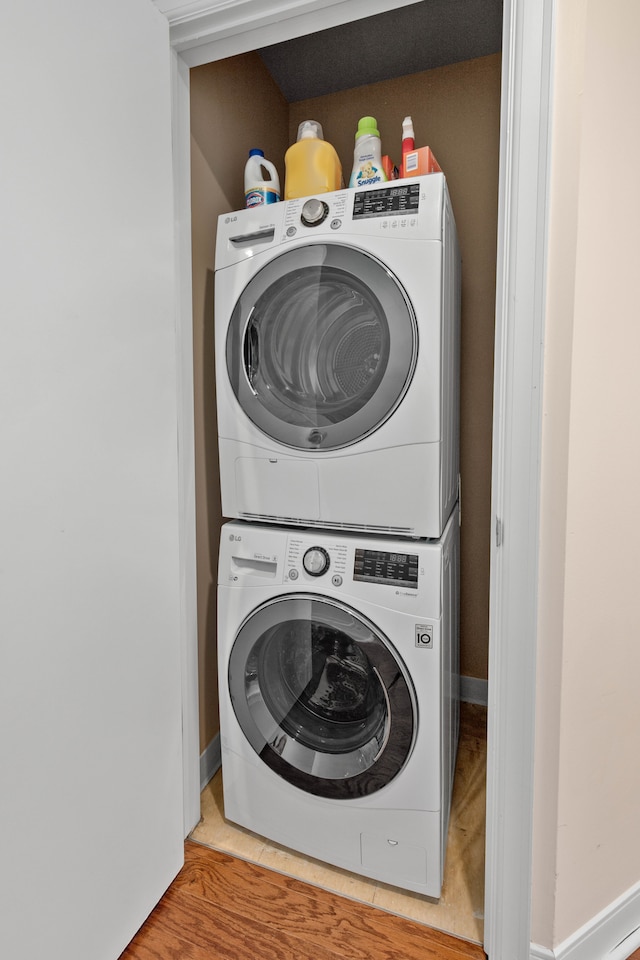 laundry room with stacked washer / dryer