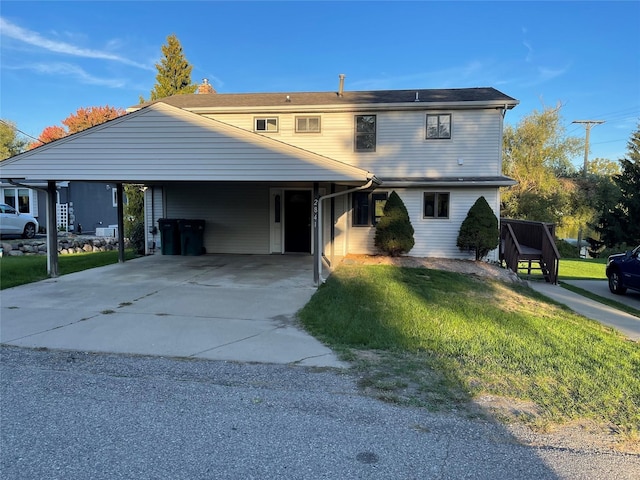 view of property featuring a front yard and a carport