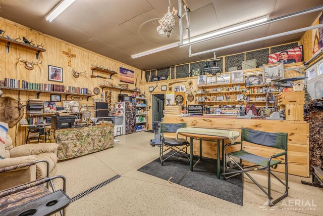 4100 Grass Lake Rd, West Branch, MI 48661 - office area featuring wood walls and speckle patterned floor
