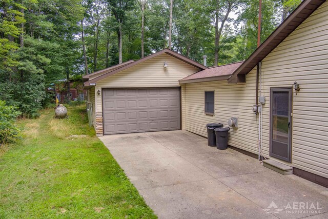 4100 Grass Lake Rd, West Branch, MI 48661 - garage with view of wooded area