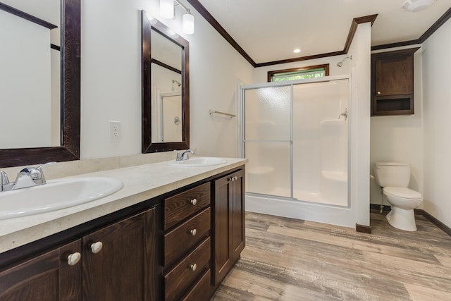 bathroom with hardwood / wood-style floors, toilet, an enclosed shower, and crown molding