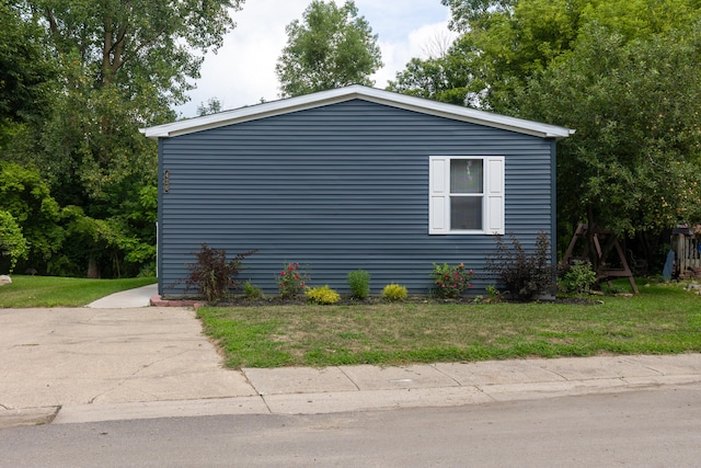 view of side of home with a lawn