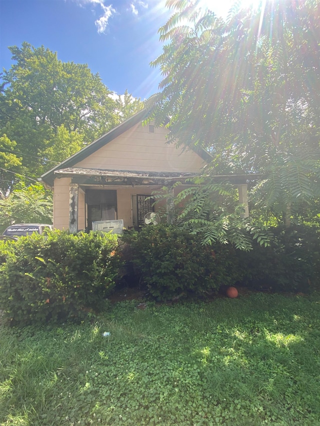 view of property exterior with a yard