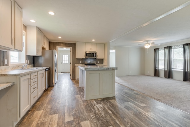 575 Gallery Dr Unit 48, Eaton Rapids, MI 48827 - kitchen with appliances with stainless steel finishes, a center island, wood finished floors, open floor plan, and a sink