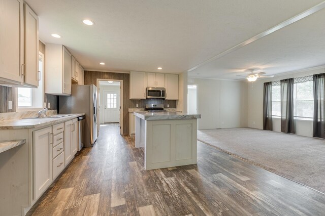575 Gallery Dr Unit 48, Eaton Rapids, MI 48827 - kitchen with appliances with stainless steel finishes, a center island, wood finished floors, open floor plan, and a sink