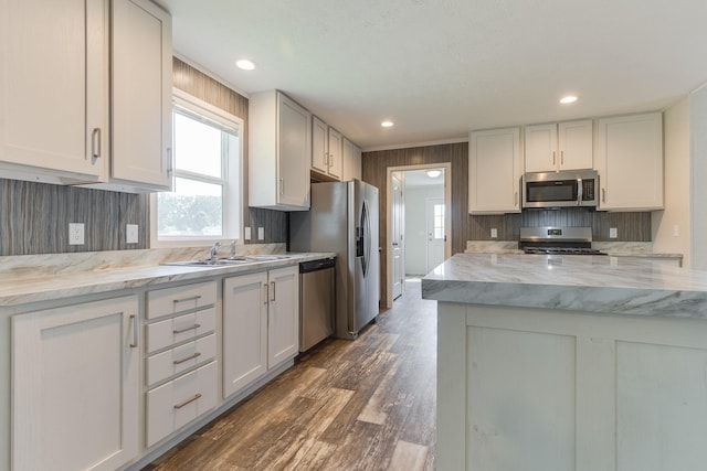 575 Gallery Dr Unit 48, Eaton Rapids, MI 48827 - kitchen with appliances with stainless steel finishes, backsplash, dark wood finished floors, plenty of natural light, and recessed lighting