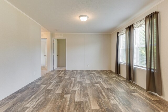 575 Gallery Dr Unit 48, Eaton Rapids, MI 48827 - unfurnished room featuring wood finished floors, healthy amount of natural light, and crown molding