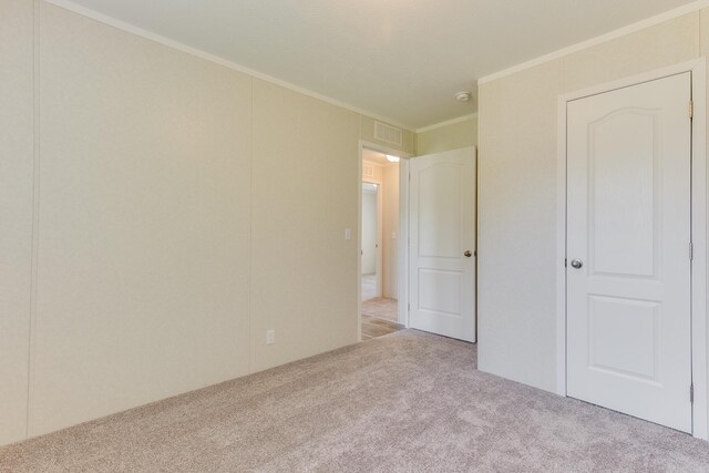 575 Gallery Dr Unit 48, Eaton Rapids, MI 48827 - unfurnished bedroom with carpet flooring and crown molding