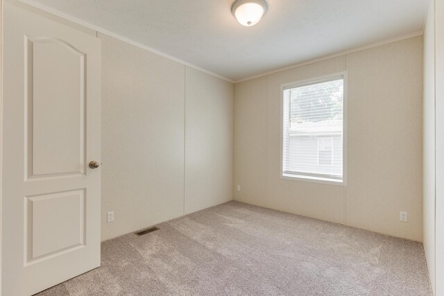 575 Gallery Dr Unit 48, Eaton Rapids, MI 48827 - carpeted spare room featuring crown molding