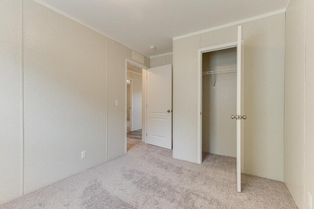 575 Gallery Dr Unit 48, Eaton Rapids, MI 48827 - unfurnished bedroom with carpet and crown molding
