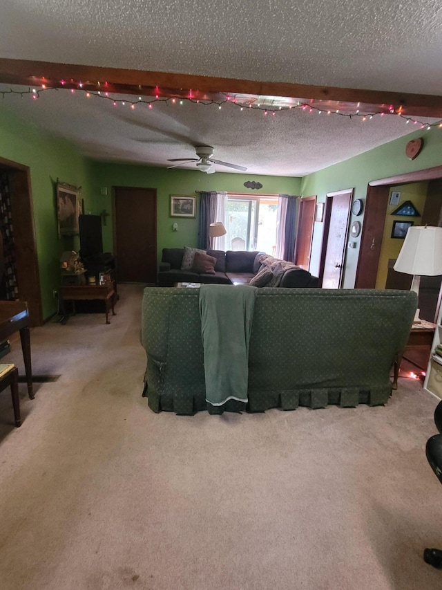 carpeted living room featuring ceiling fan and a textured ceiling