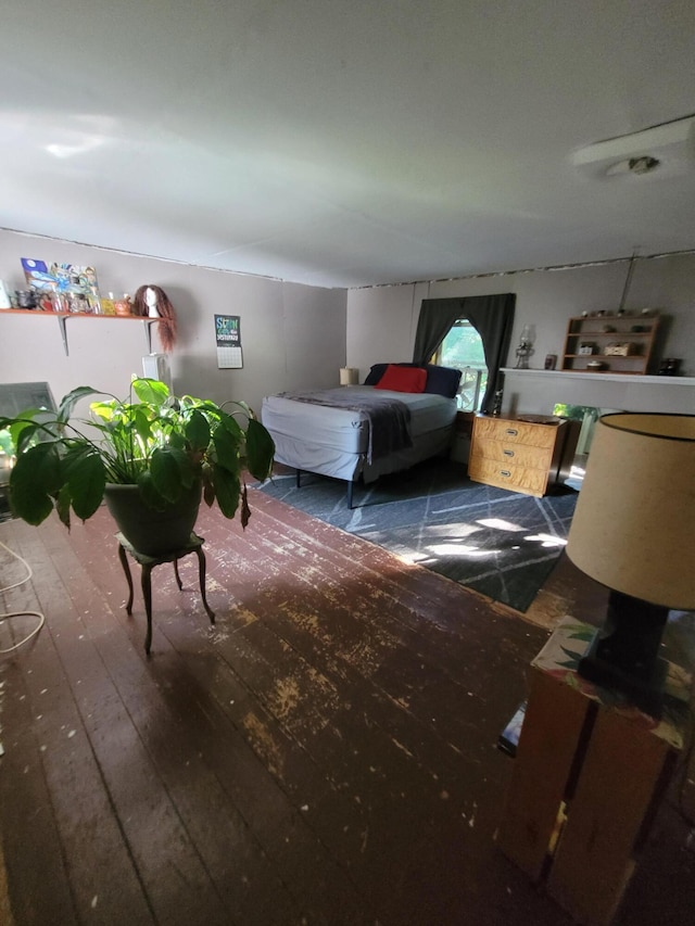 bedroom with dark hardwood / wood-style floors