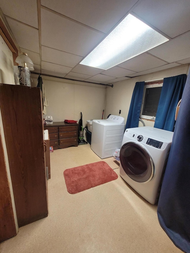 washroom with washing machine and dryer and light carpet