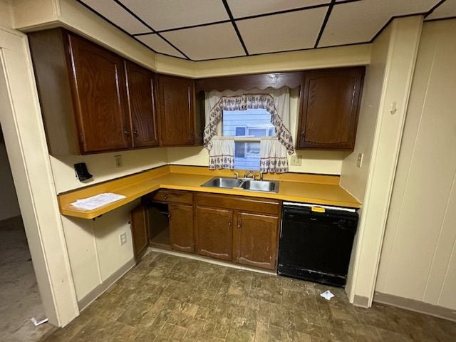 kitchen featuring a paneled ceiling, dishwasher, dark brown cabinets, and sink