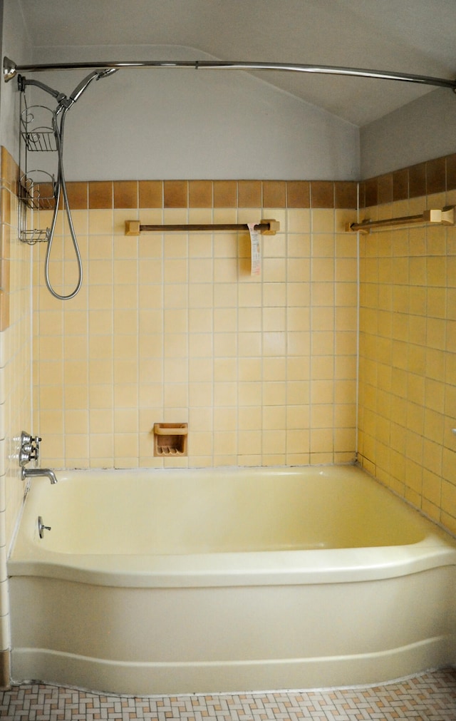 bathroom featuring tile patterned flooring and tiled shower / bath combo