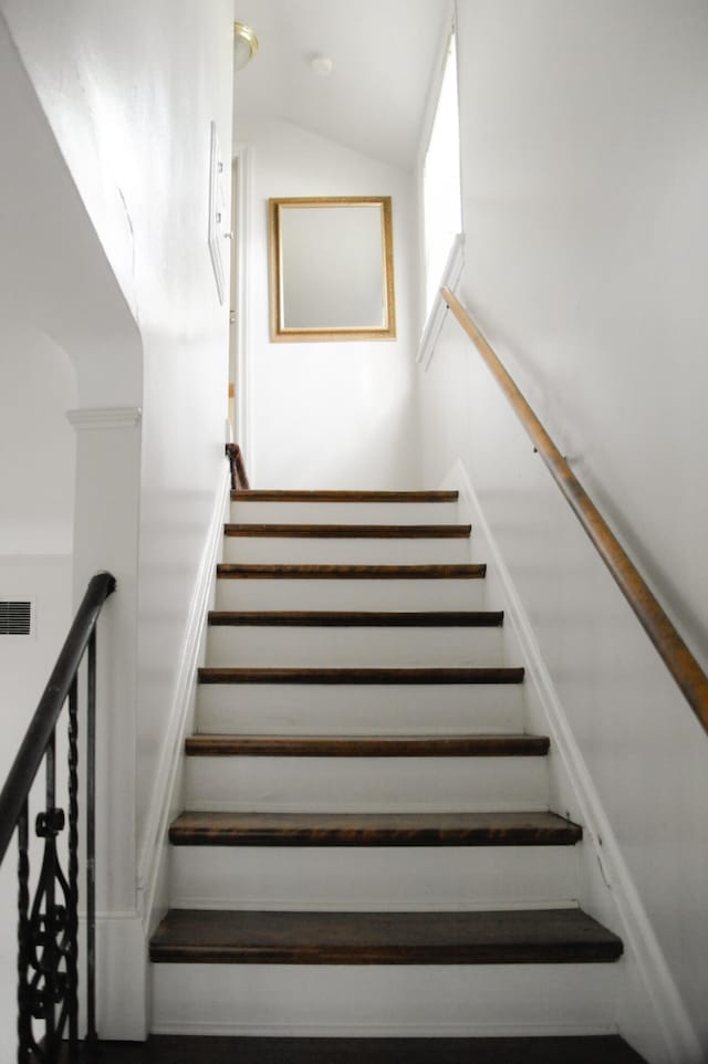 staircase with lofted ceiling