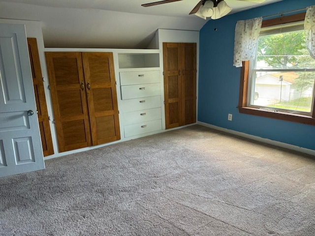 unfurnished bedroom with ceiling fan, carpet, and vaulted ceiling