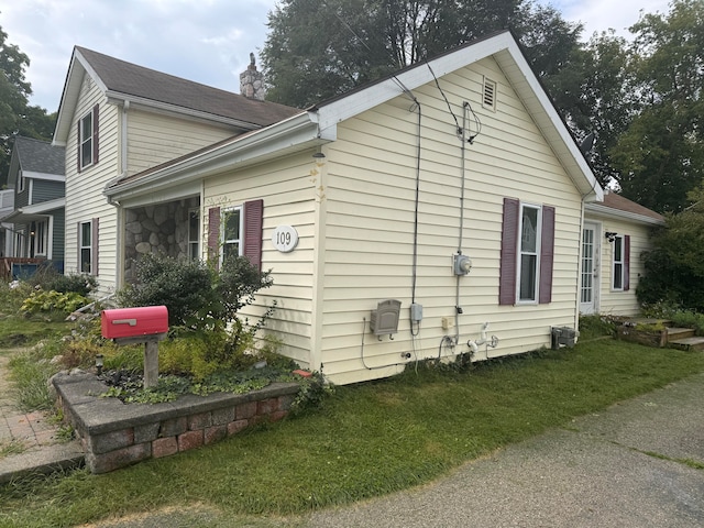 view of home's exterior with a lawn