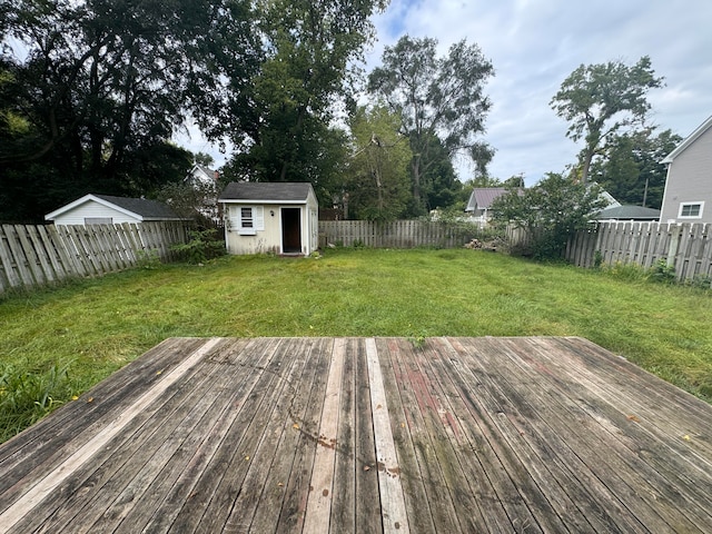 wooden deck with an outbuilding and a yard