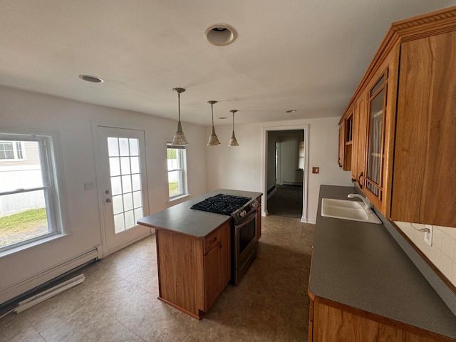 kitchen featuring stainless steel stove, a wealth of natural light, a baseboard heating unit, and sink