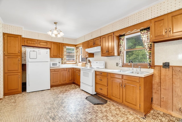 kitchen featuring pendant lighting, white appliances, a healthy amount of sunlight, and sink