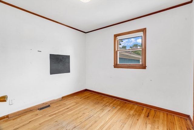 unfurnished room with hardwood / wood-style flooring and ornamental molding